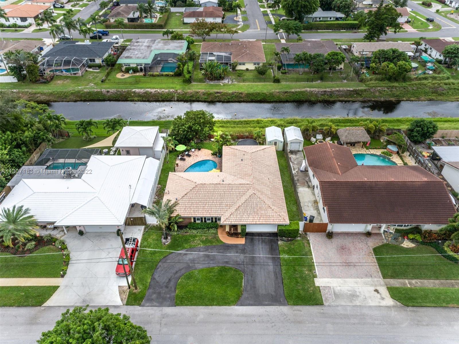 1592 Northwest 8th Street Boca Raton, FL 33486 - Photo 35 of 35 an aerial view of a house with garden space and lake view