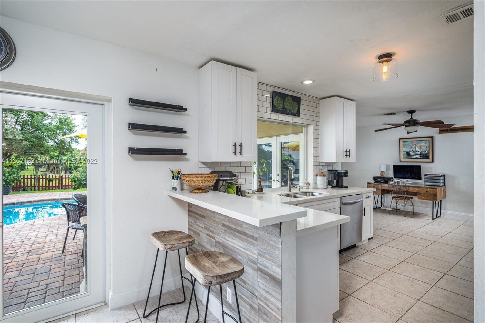 1592 Northwest 8th Street Boca Raton, FL 33486 - Photo 5 of 35 a kitchen with appliances cabinets and a counter top space