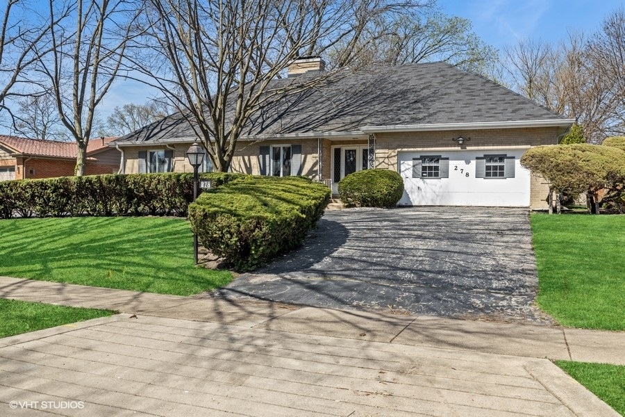 278 Longcommon Road Riverside, IL 60546 - Photo 1 of 36 a front view of a house with a garden