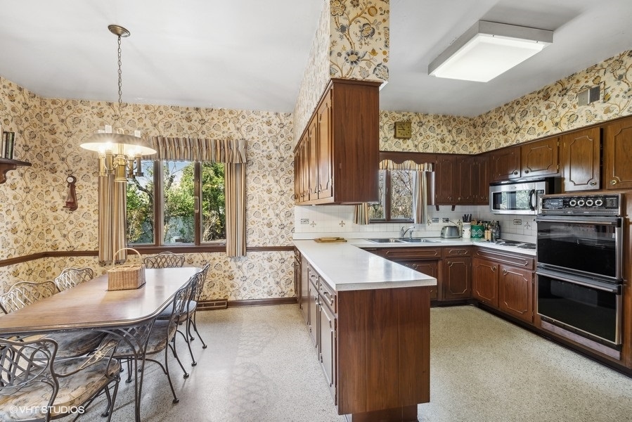 278 Longcommon Road Riverside, IL 60546 - Photo 11 of 36 a kitchen with stainless steel appliances granite countertop a sink a stove and a wooden floors