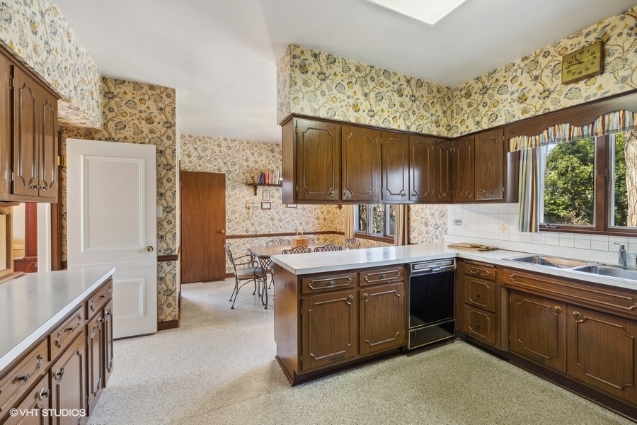278 Longcommon Road Riverside, IL 60546 - Photo 13 of 36 a kitchen with a sink stove and cabinets