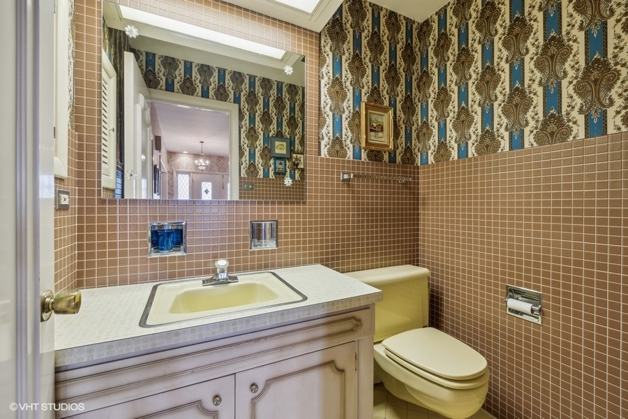 278 Longcommon Road Riverside, IL 60546 - Photo 17 of 36 a bathroom with a granite countertop toilet a sink and mirror