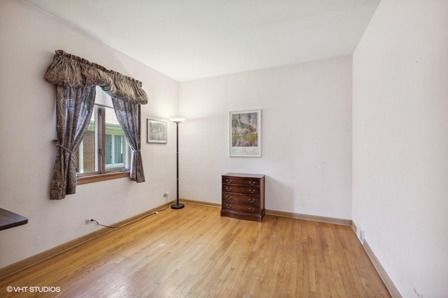 278 Longcommon Road Riverside, IL 60546 - Photo 21 of 36 a view of empty room with wooden floor and fan