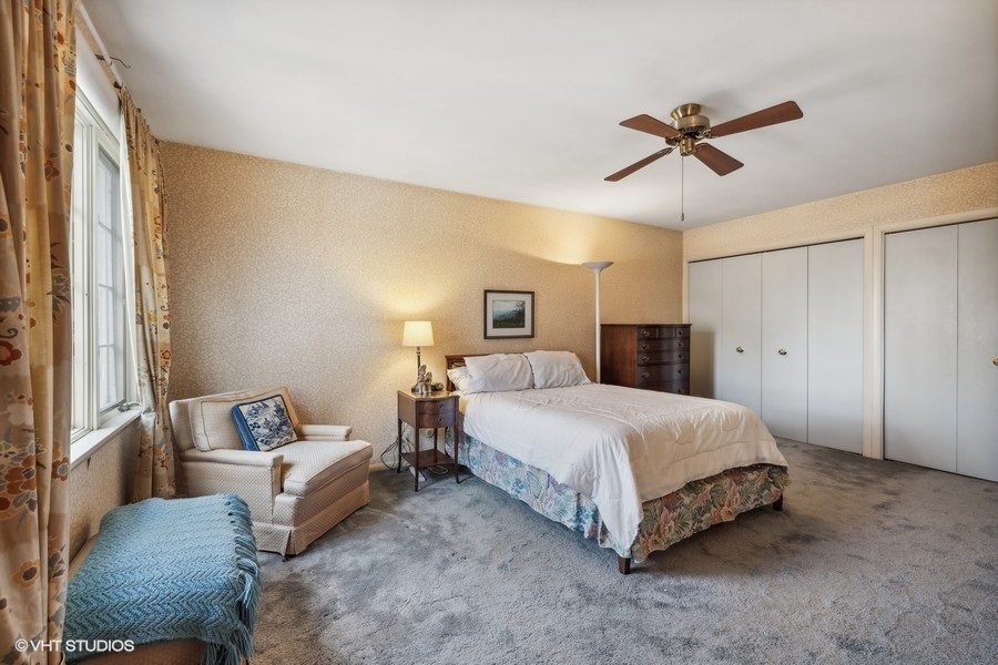 278 Longcommon Road Riverside, IL 60546 - Photo 26 of 36 a bedroom with a bed and a chandelier