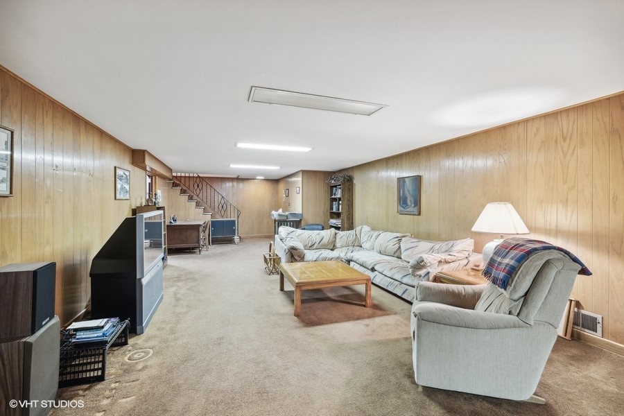 278 Longcommon Road Riverside, IL 60546 - Photo 28 of 36 a living room with furniture and a flat screen tv