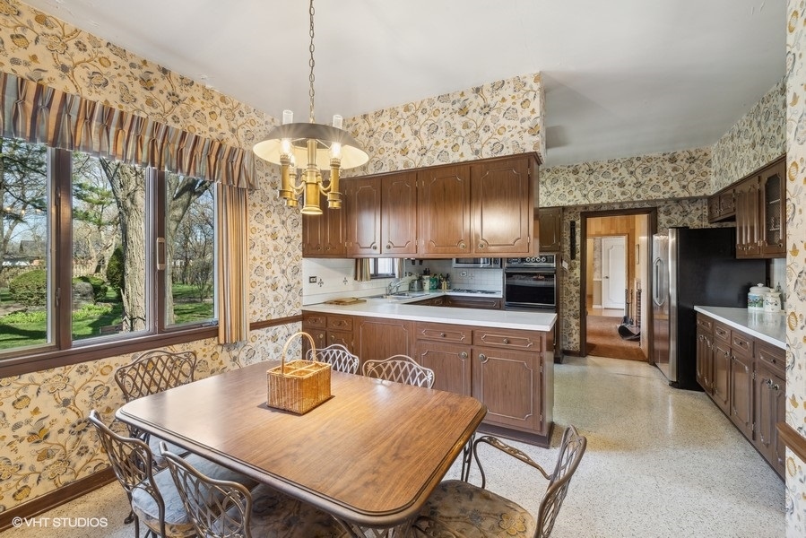 278 Longcommon Road Riverside, IL 60546 - Photo 9 of 36 a kitchen with kitchen island granite countertop a sink a counter top space and living room view