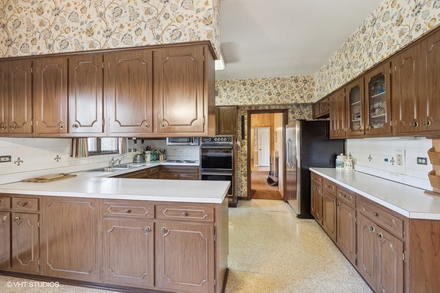278 Longcommon Road Riverside, IL 60546 - Photo 10 of 36 a kitchen with kitchen island granite countertop wooden cabinets a sink and dishwasher