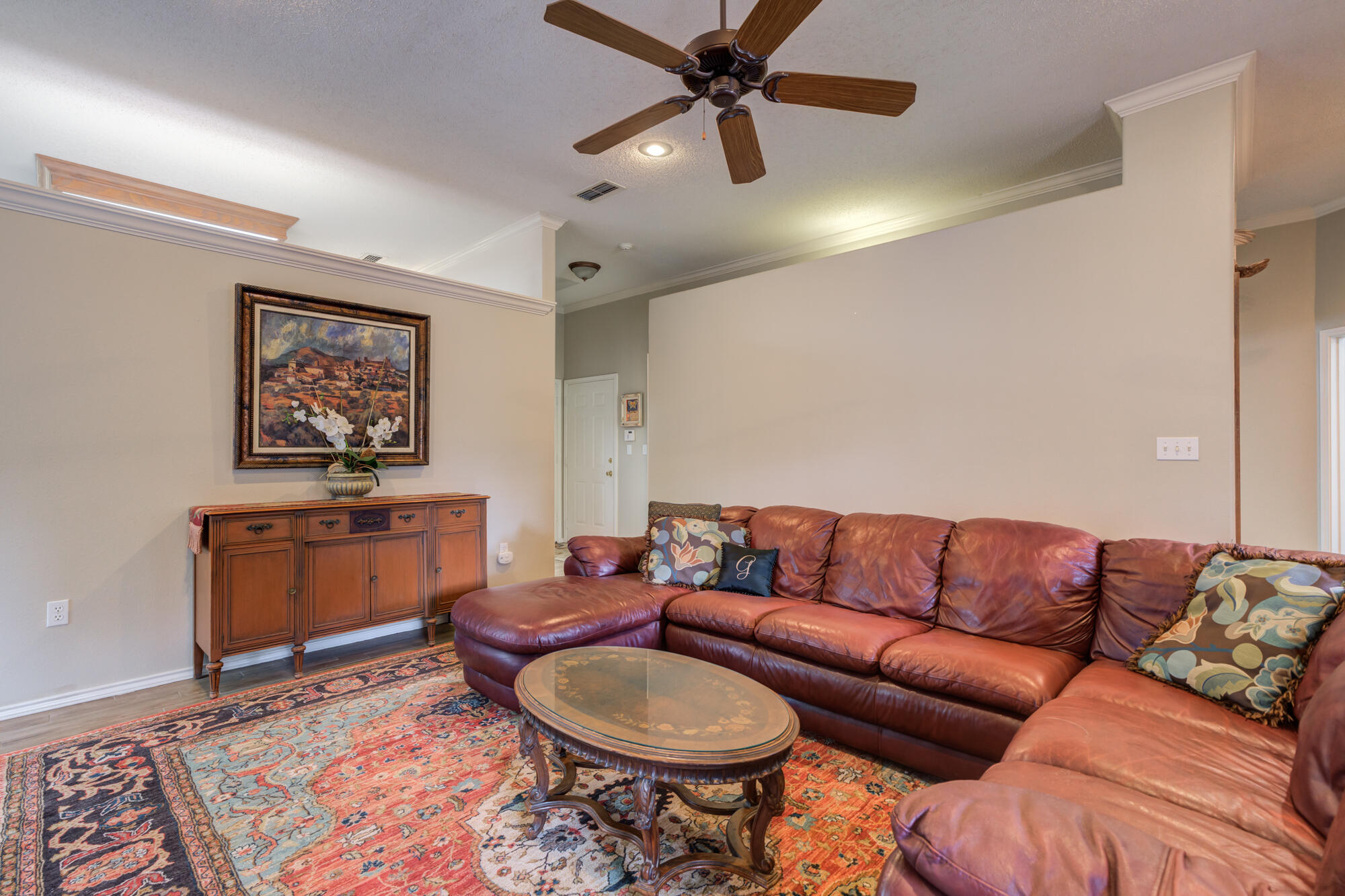 6908 Freeport Avenue Lubbock, TX 79424 - Photo 11 of 44 a living room with furniture a rug and a painting on the wall
