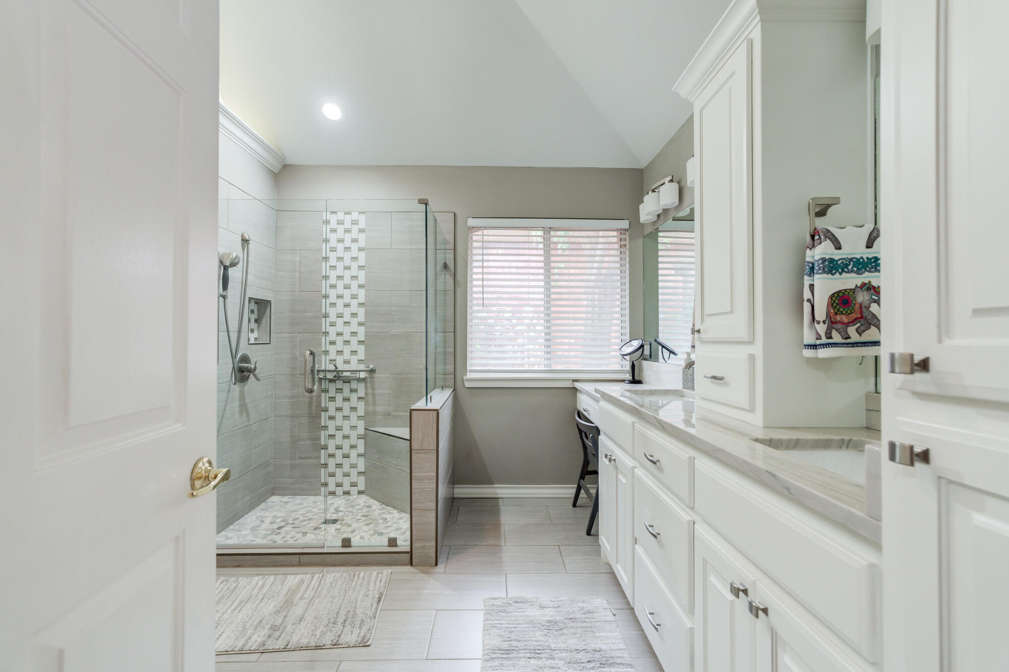 6908 Freeport Avenue Lubbock, TX 79424 - Photo 25 of 44 a spacious bathroom with a granite countertop sink and a mirror