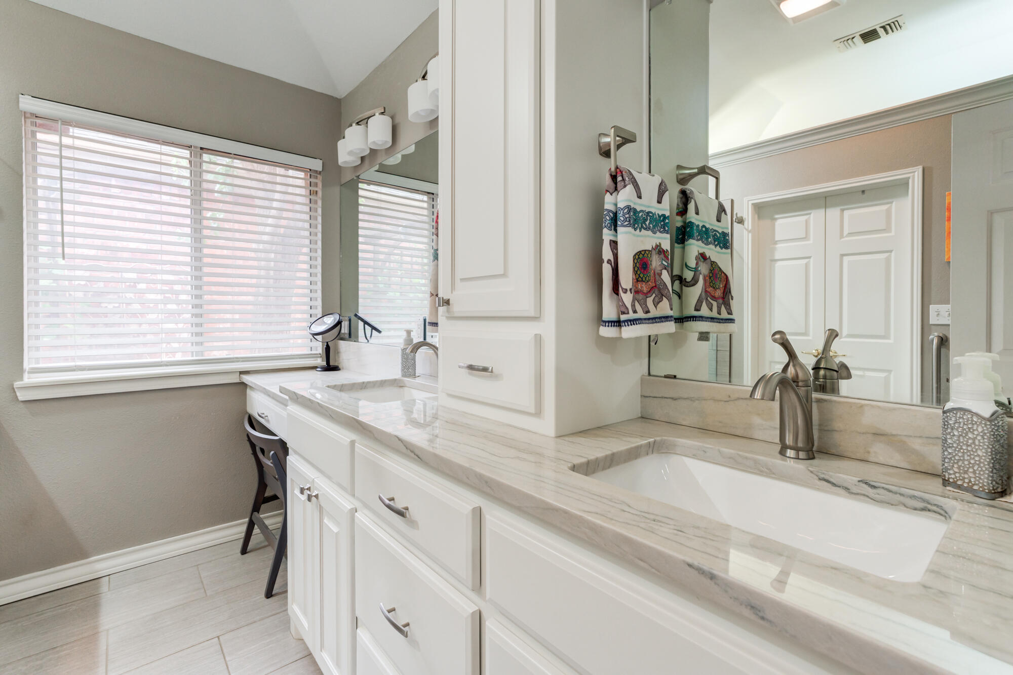 6908 Freeport Avenue Lubbock, TX 79424 - Photo 26 of 44 a bathroom with a granite countertop sink and a window