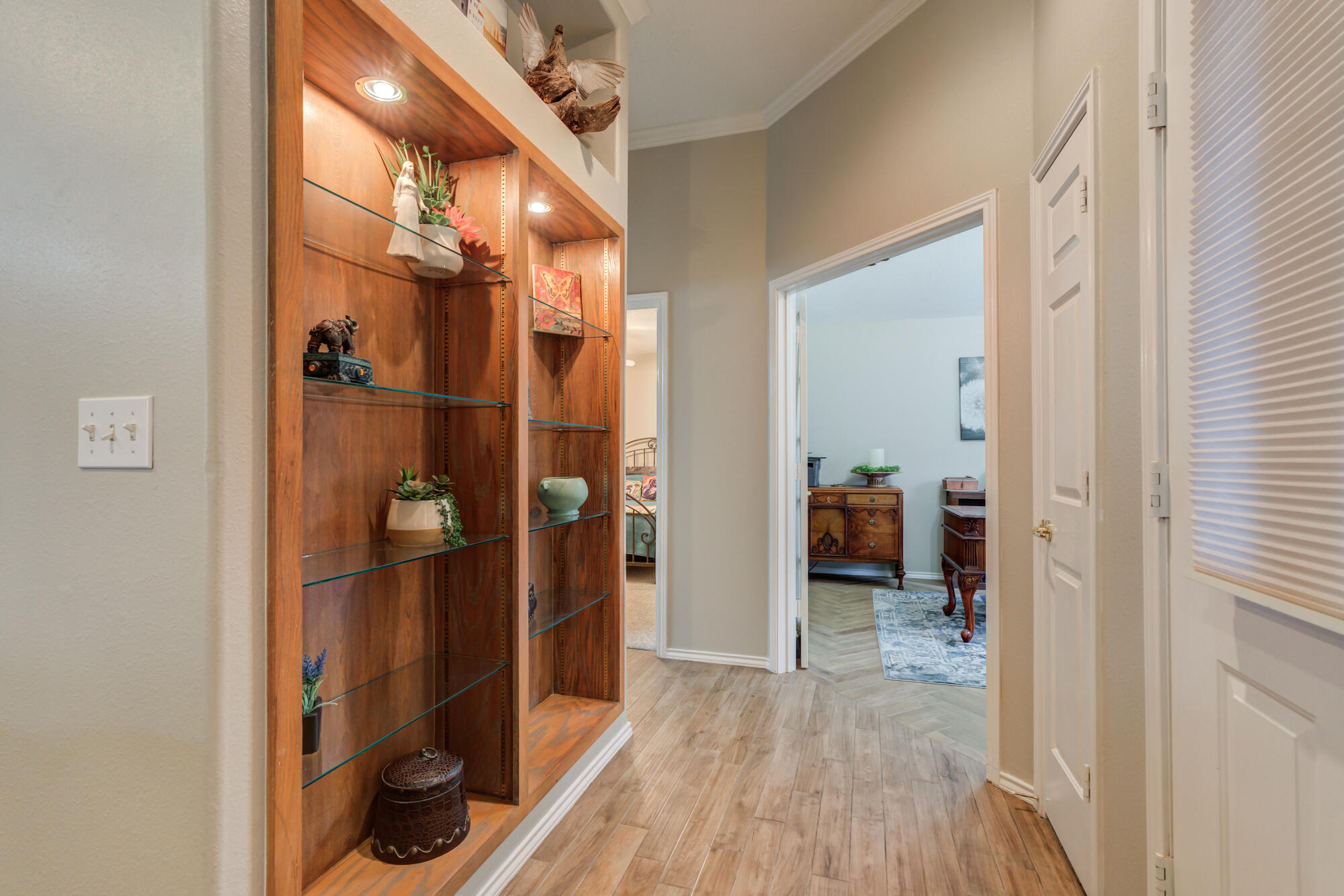 6908 Freeport Avenue Lubbock, TX 79424 - Photo 30 of 44 a view of a hallway with wooden floor and a bathroom