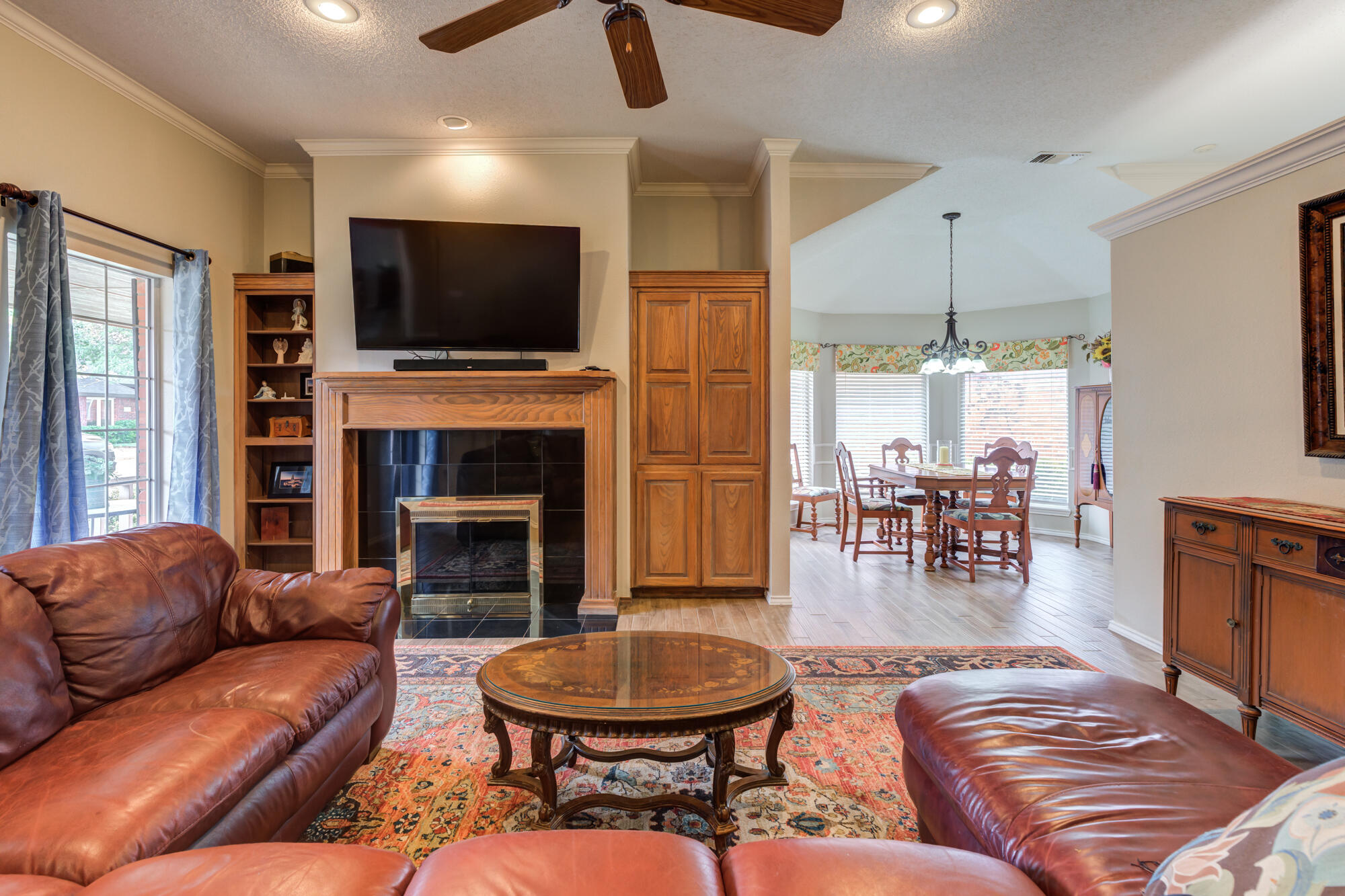 6908 Freeport Avenue Lubbock, TX 79424 - Photo 7 of 44 a living room with furniture a flat screen tv and a fireplace