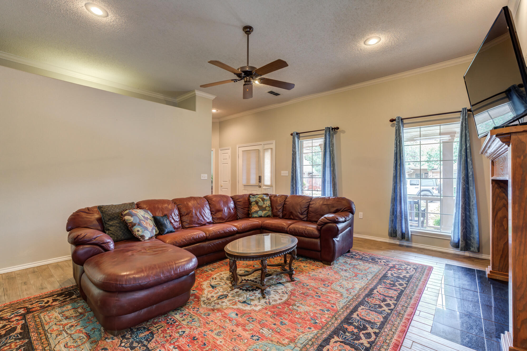 6908 Freeport Avenue Lubbock, TX 79424 - Photo 10 of 44 a living room with furniture a ceiling fan a rug and a window