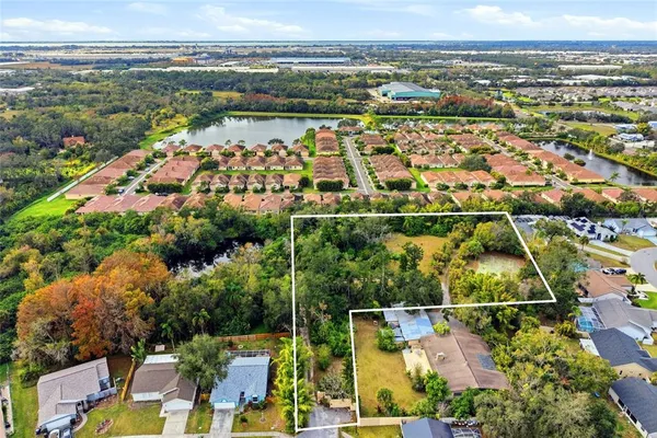 an aerial view of residential houses with outdoor space