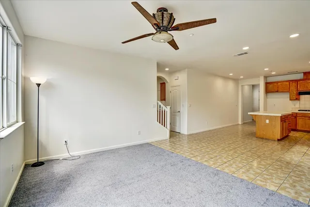 an empty room with a fireplace and window