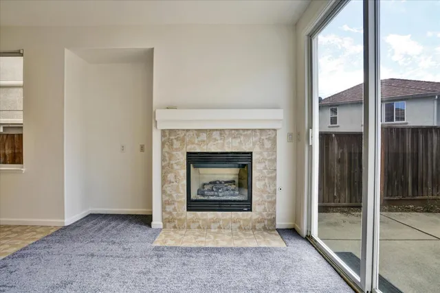 a view of a hallway to a livingroom with wooden floor and staircase