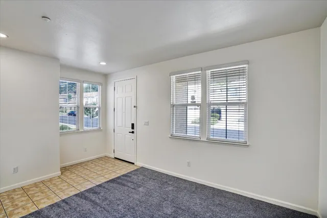 a kitchen that has a kitchen island wooden cabinets and stainless steel appliances