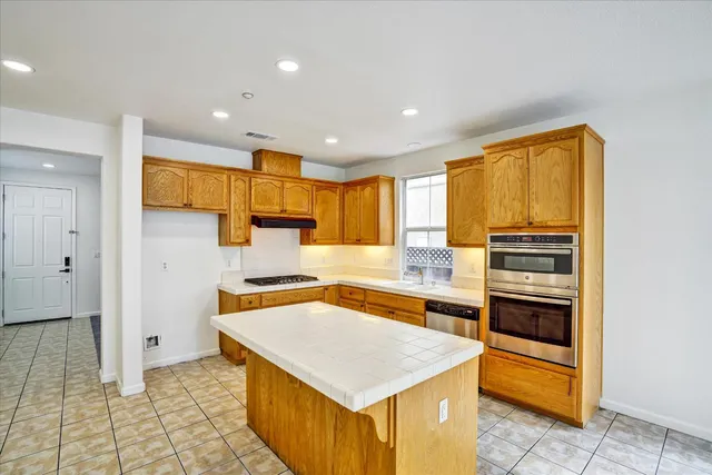 a kitchen with stainless steel appliances a stove and a refrigerator
