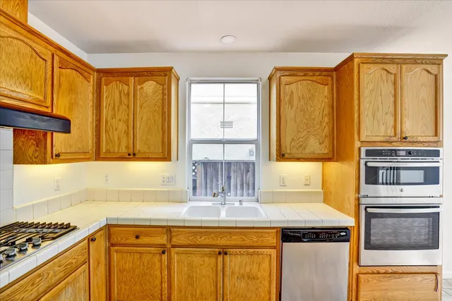 a view of a livingroom with wooden floor and stairs