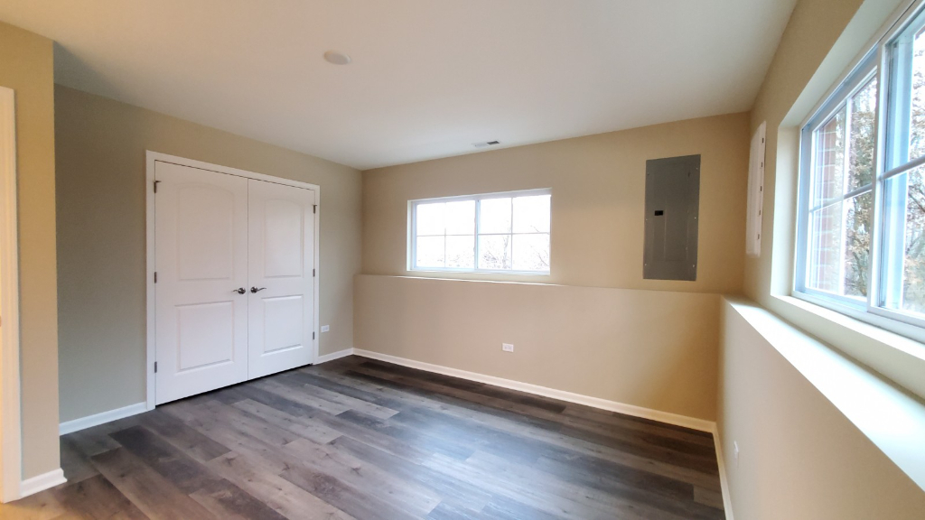 241 Timber Ridge Court Joliet, IL 60431 - Photo 14 of 14 a view of an empty room with wooden floor and a window