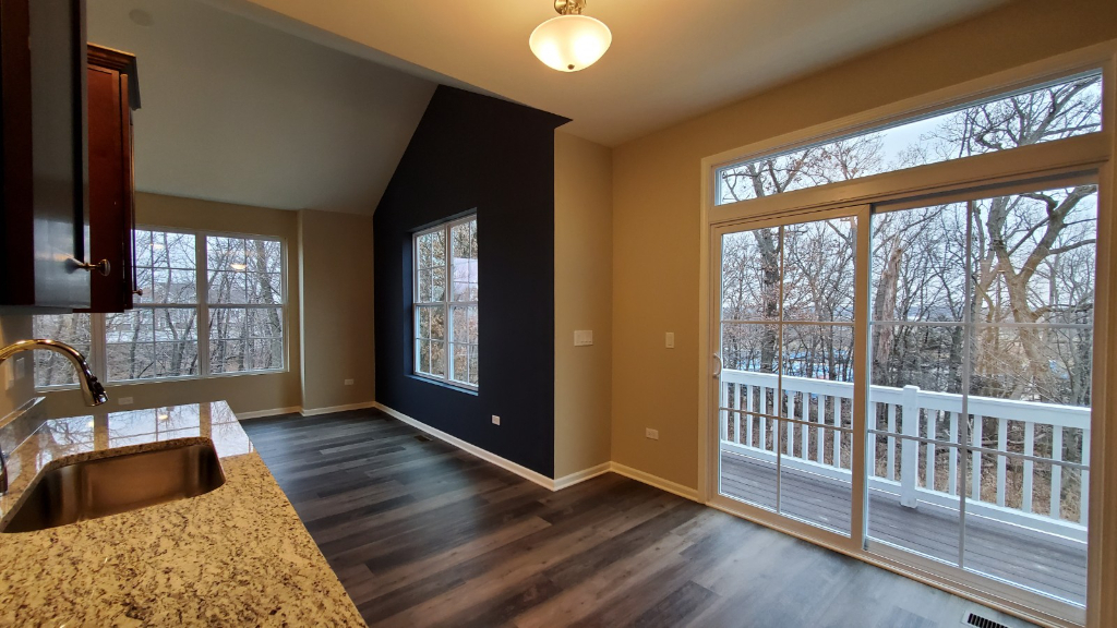 241 Timber Ridge Court Joliet, IL 60431 - Photo 4 of 14 an empty room with wooden floor and windows