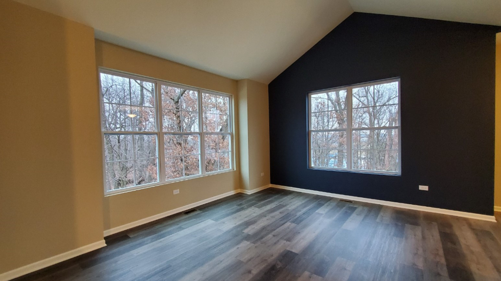 241 Timber Ridge Court Joliet, IL 60431 - Photo 9 of 14 an empty room with wooden floor and windows