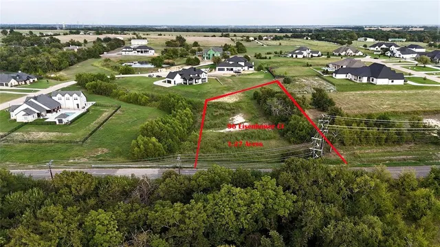 an aerial view of residential houses with outdoor space and swimming pool