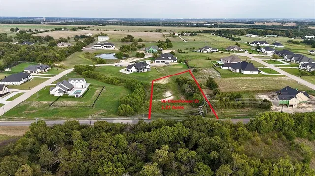 an aerial view of residential houses with outdoor space and swimming pool