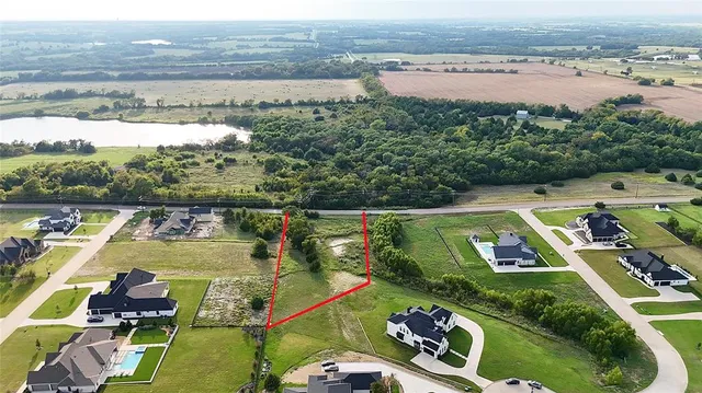 a view of a lake with a table and chairs