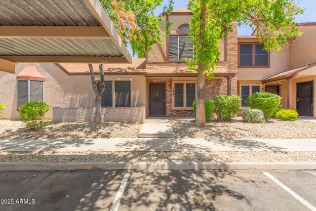 a view of a house with a yard and plants