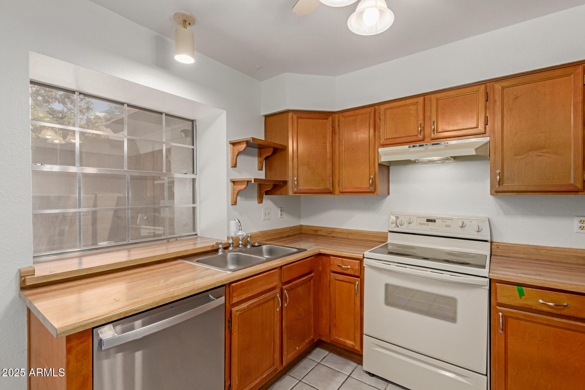 7977 West Wacker Road, Unit 244 Peoria, AZ 85381 - Photo 10 of 34 a kitchen with granite countertop cabinets stainless steel appliances and a sink