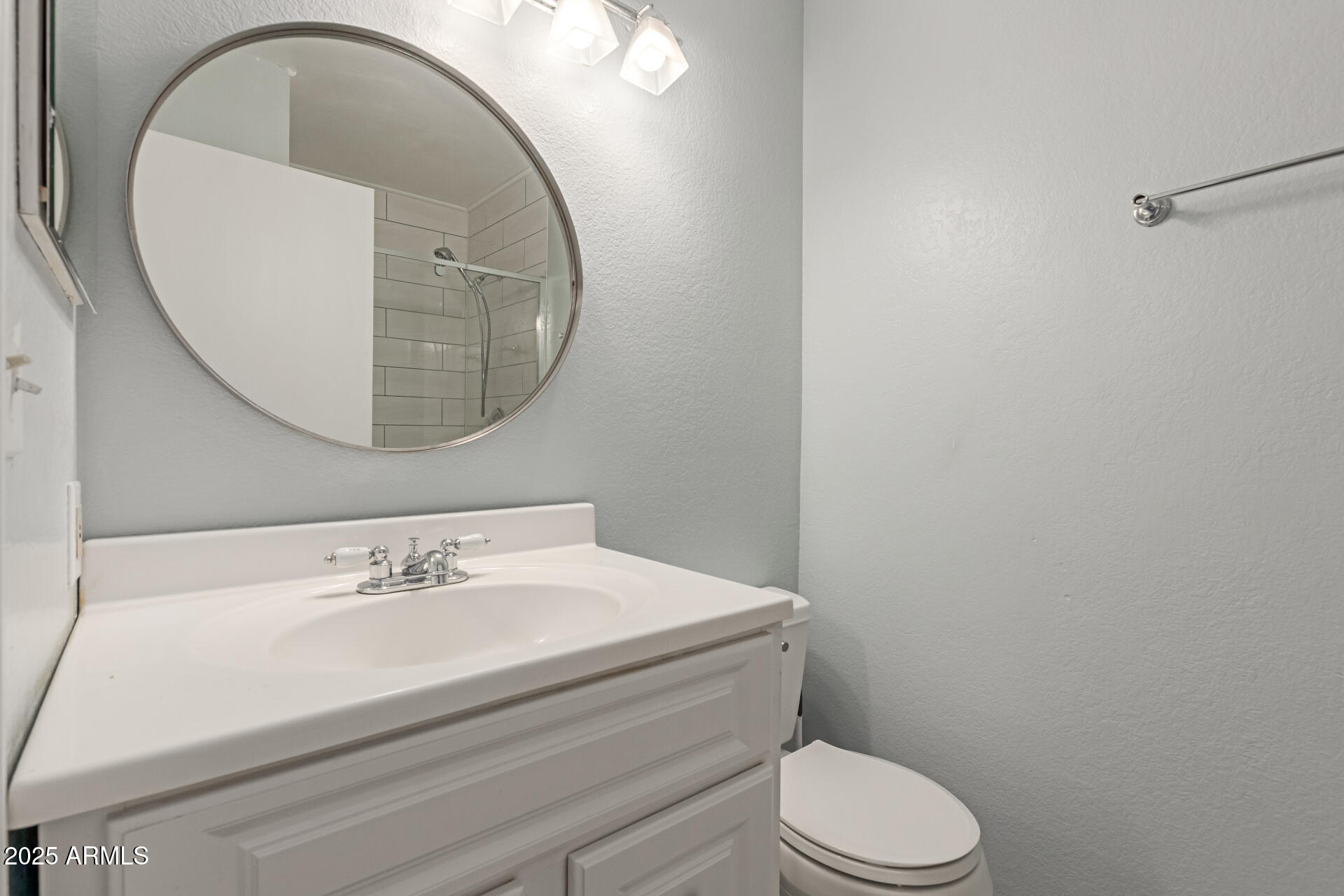 7977 West Wacker Road, Unit 244 Peoria, AZ 85381 - Photo 22 of 34 a bathroom with a sink mirror and toilet