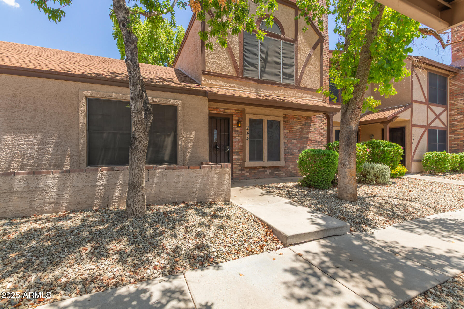 7977 West Wacker Road, Unit 244 Peoria, AZ 85381 - Photo 2 of 34 a view of a house with a yard