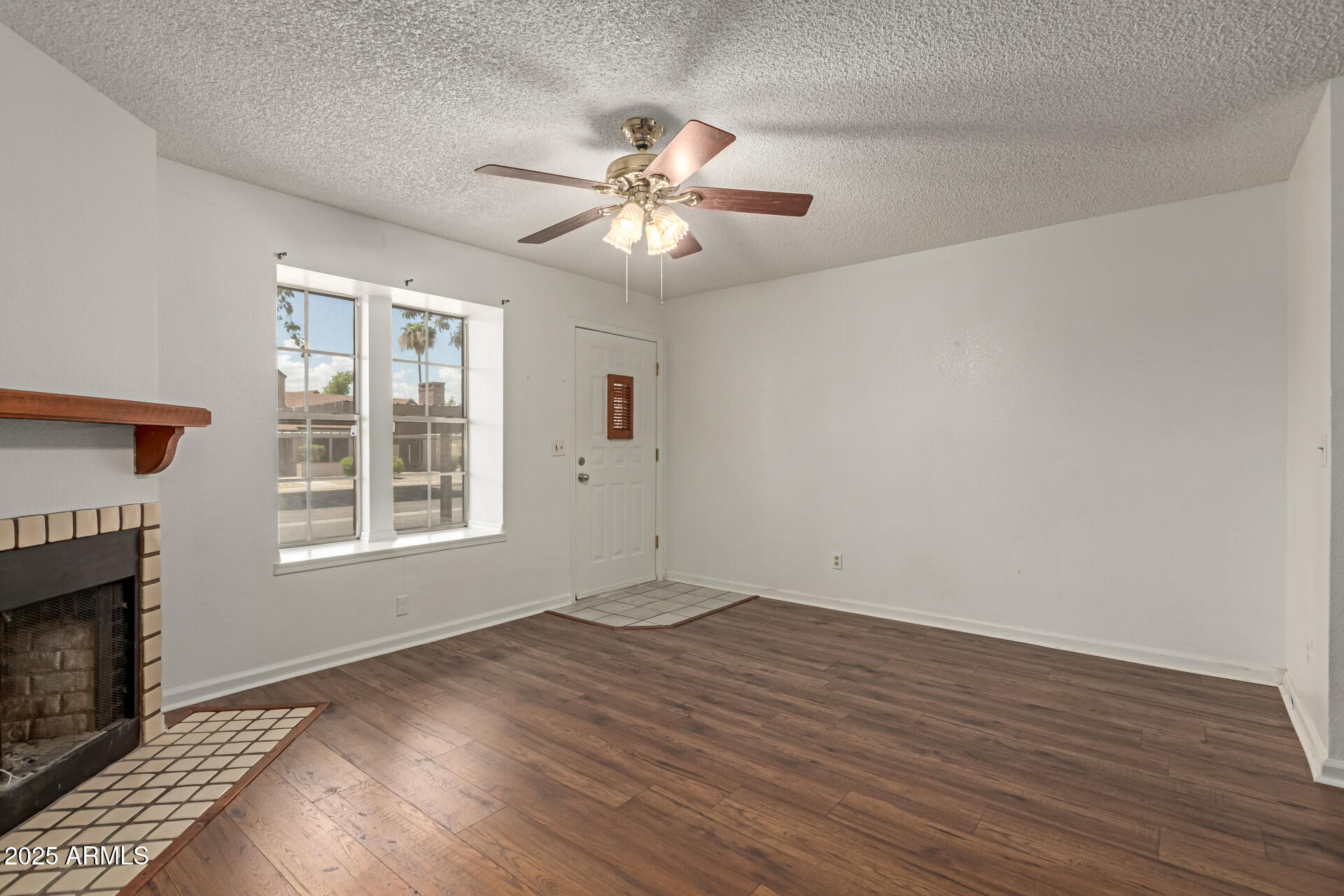 7977 West Wacker Road, Unit 244 Peoria, AZ 85381 - Photo 6 of 34 wooden floor in an empty room with a window