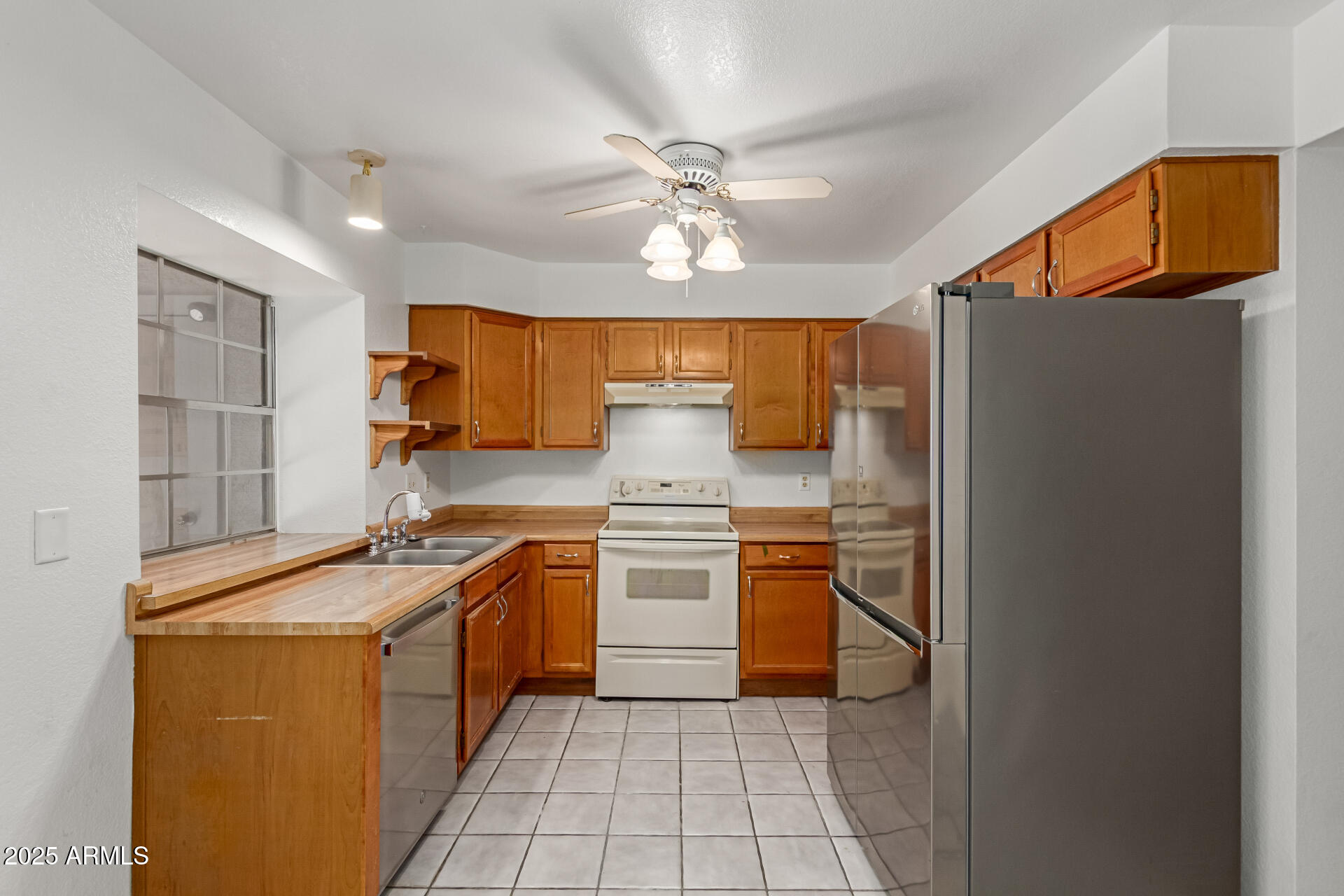 7977 West Wacker Road, Unit 244 Peoria, AZ 85381 - Photo 7 of 34 a kitchen with stainless steel appliances granite countertop a sink stove and refrigerator