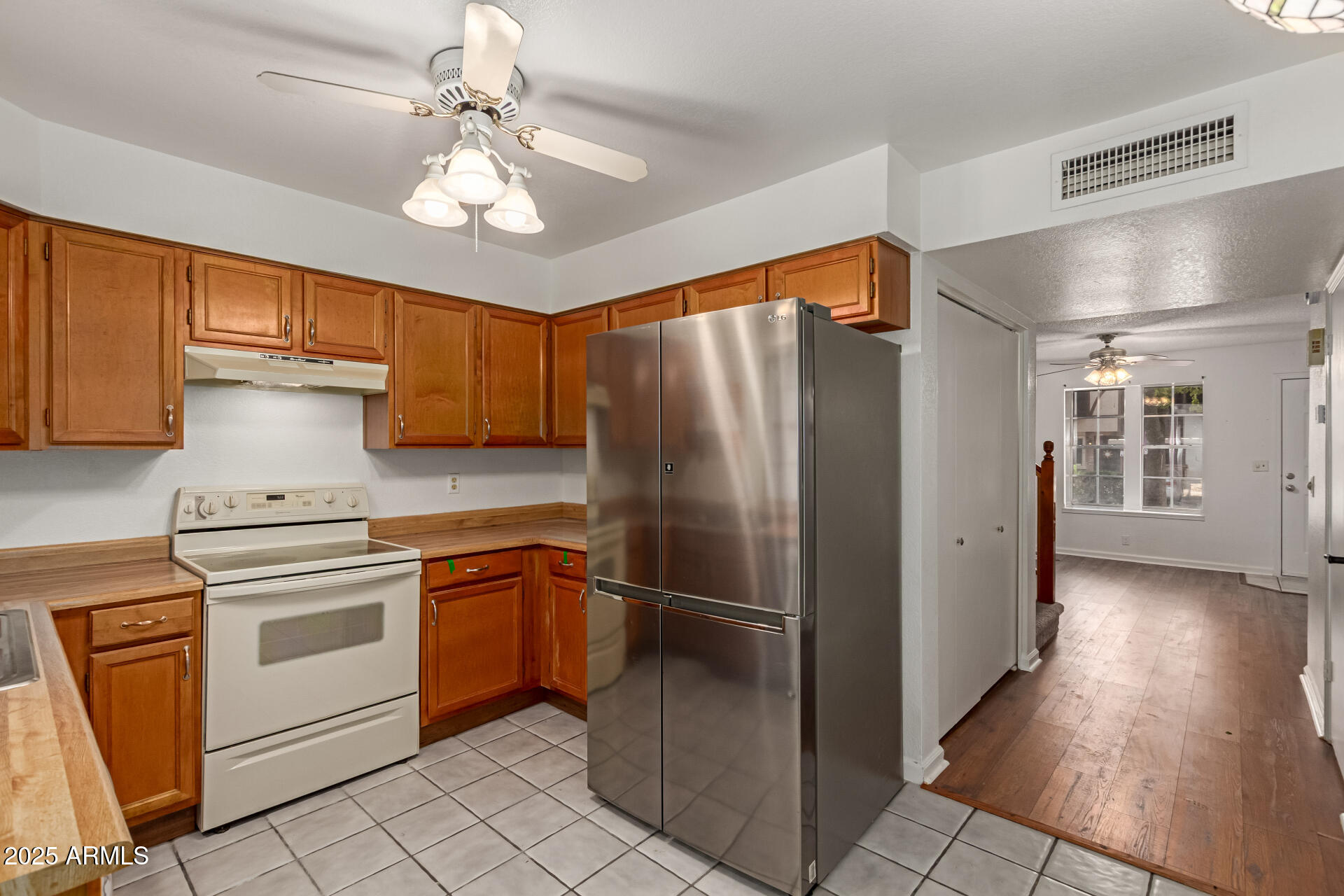 7977 West Wacker Road, Unit 244 Peoria, AZ 85381 - Photo 8 of 34 a kitchen with stainless steel appliances a refrigerator sink and cabinets