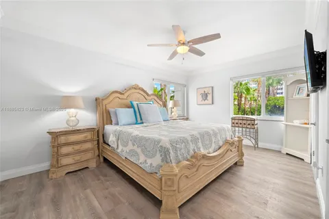 a large bed sitting in a bedroom next to a window
