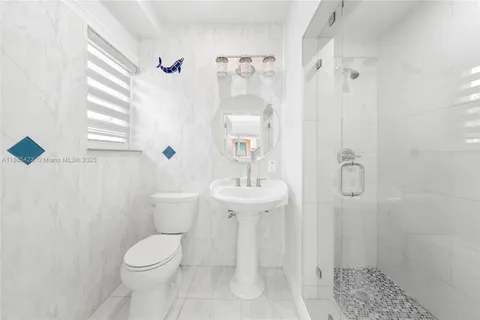a bathroom with a toilet sink and shower