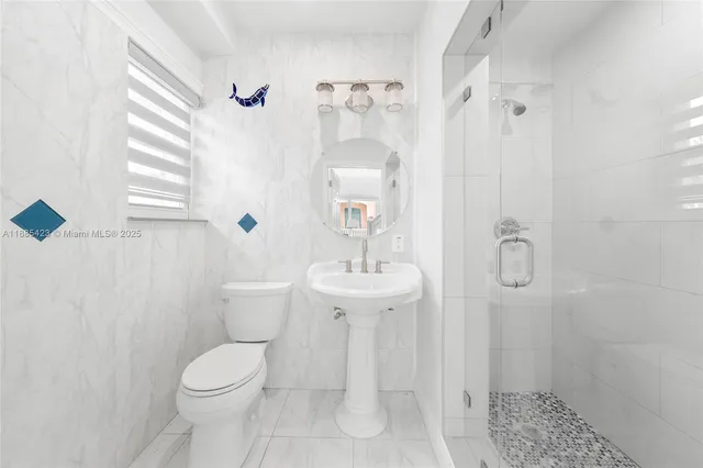 a bathroom with a toilet sink and shower