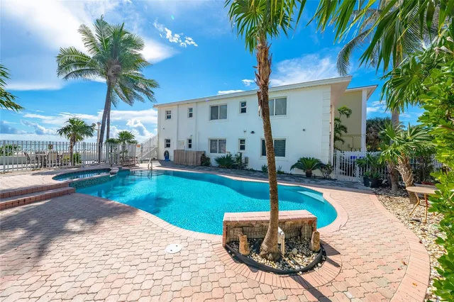 a swimming pool with outdoor seating and yard