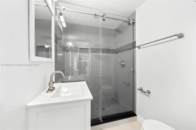a bathroom with a sink toilet and shower
