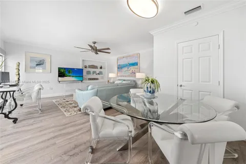 a dining room with furniture and a wooden floor