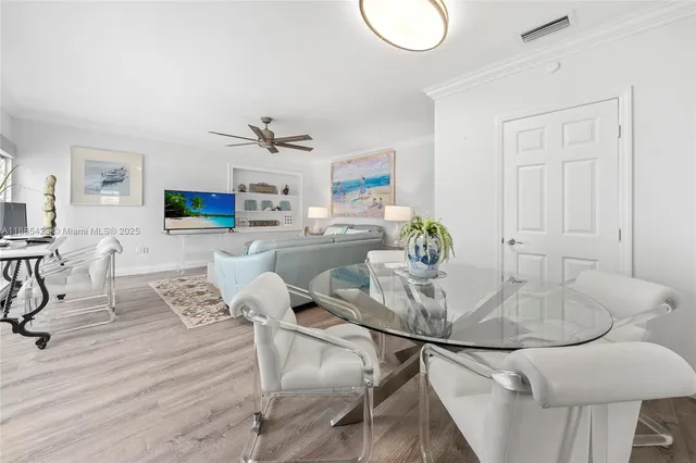 a dining room with furniture and a wooden floor
