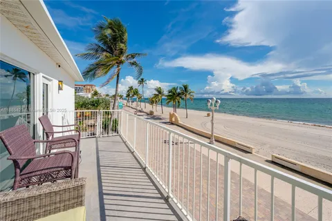 a view of a chairs and table on the balcony