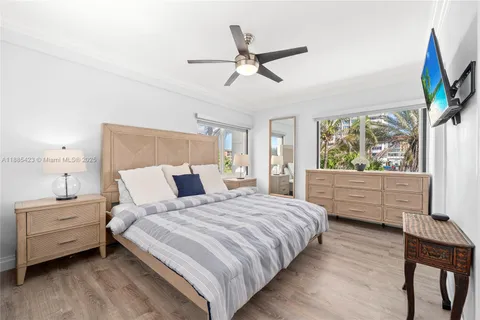 a bedroom with a large bed and a large window