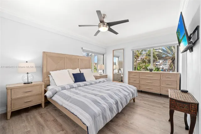 a bedroom with a large bed and a large window