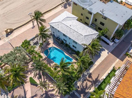 an aerial view of a house with a yard and potted plants