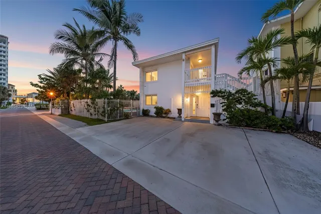 a house with palm tree in front of it