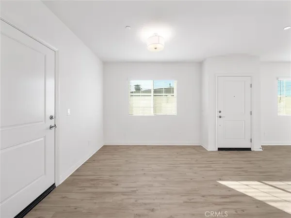 a view of kitchen with wooden floor and electronic appliances