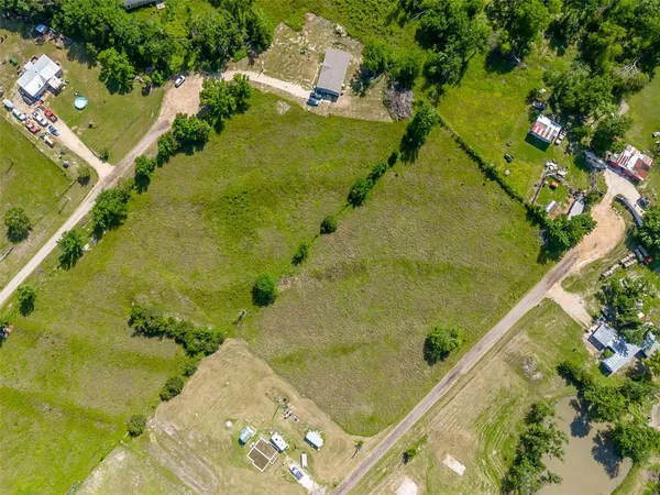 an aerial view of a residential houses with outdoor space